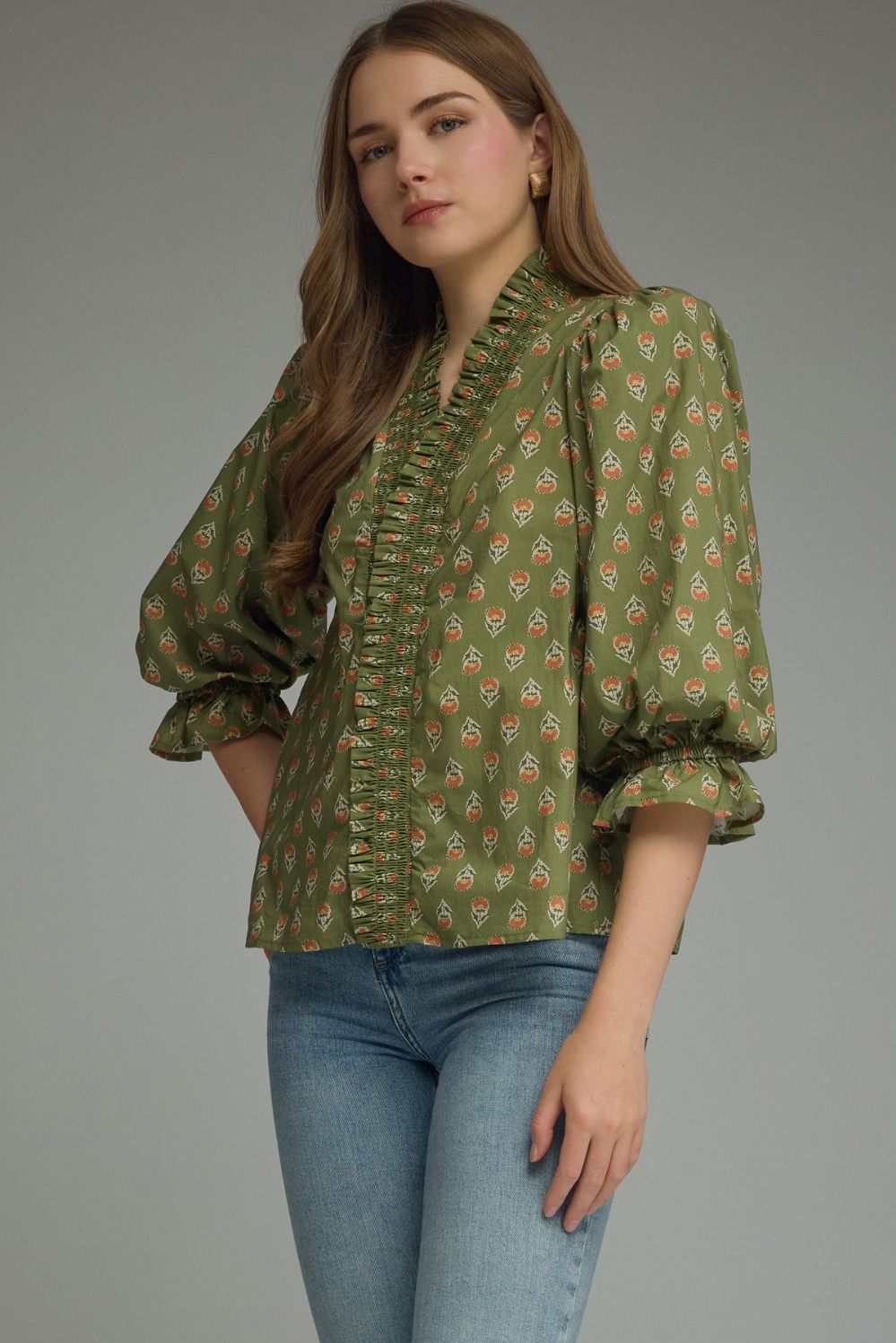 Entro-Print ¾ puff sleeve top featuring smocked V-neck detail. Ruffle detail at sleeve hem. Unlined. Woven. Non-sheer. Lightweight.