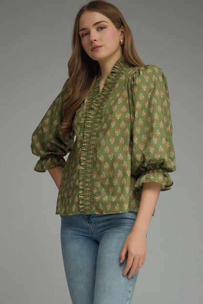 Entro-Print ¾ puff sleeve top featuring smocked V-neck detail. Ruffle detail at sleeve hem. Unlined. Woven. Non-sheer. Lightweight.