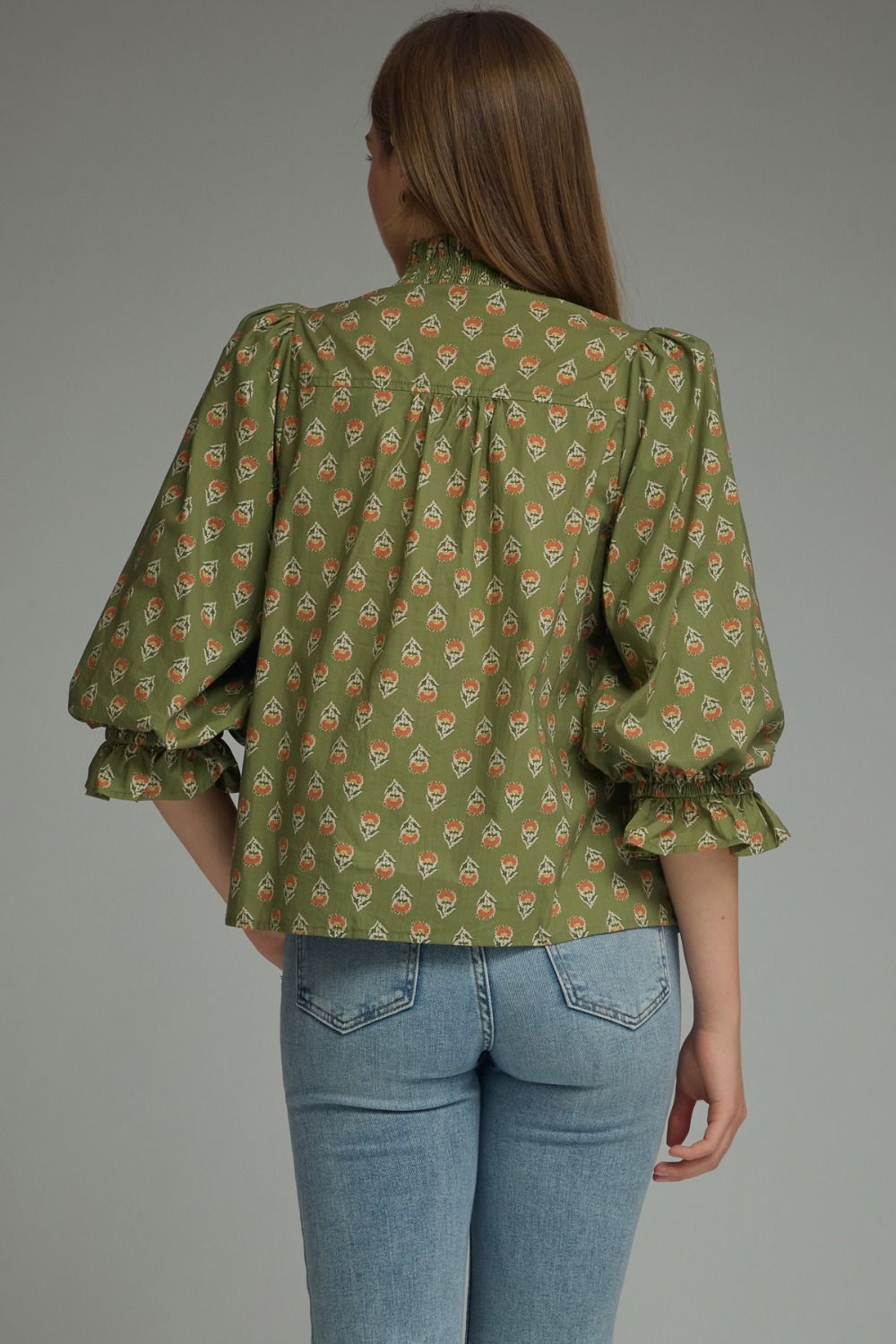 Entro-Print ¾ puff sleeve top featuring smocked V-neck detail. Ruffle detail at sleeve hem. Unlined. Woven. Non-sheer. Lightweight.