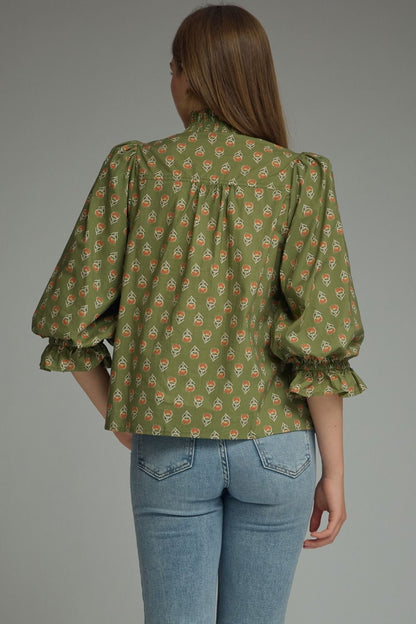 Entro-Print ¾ puff sleeve top featuring smocked V-neck detail. Ruffle detail at sleeve hem. Unlined. Woven. Non-sheer. Lightweight.