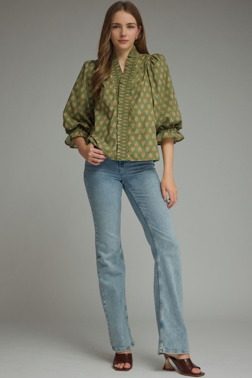 Entro-Print ¾ puff sleeve top featuring smocked V-neck detail. Ruffle detail at sleeve hem. Unlined. Woven. Non-sheer. Lightweight.