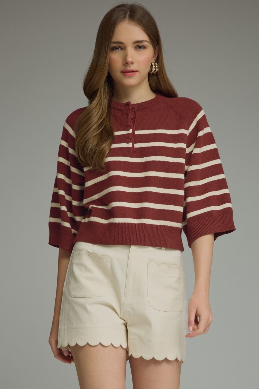 Entro-Stripe ¾ sleeve knit top featuring button closure at front.