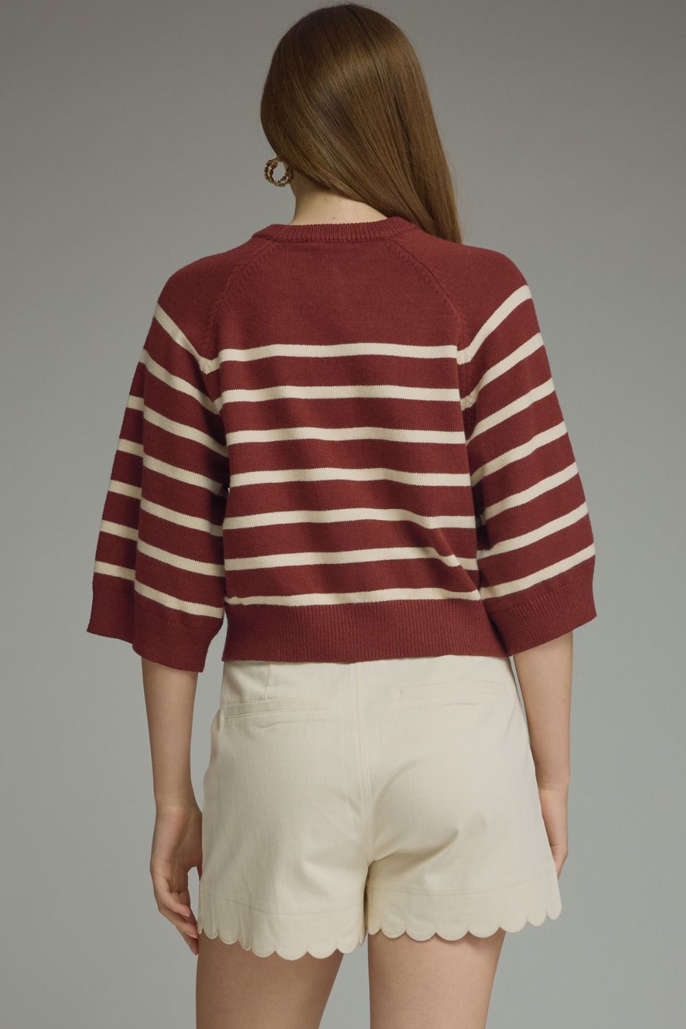 Entro-Stripe ¾ sleeve knit top featuring button closure at front.