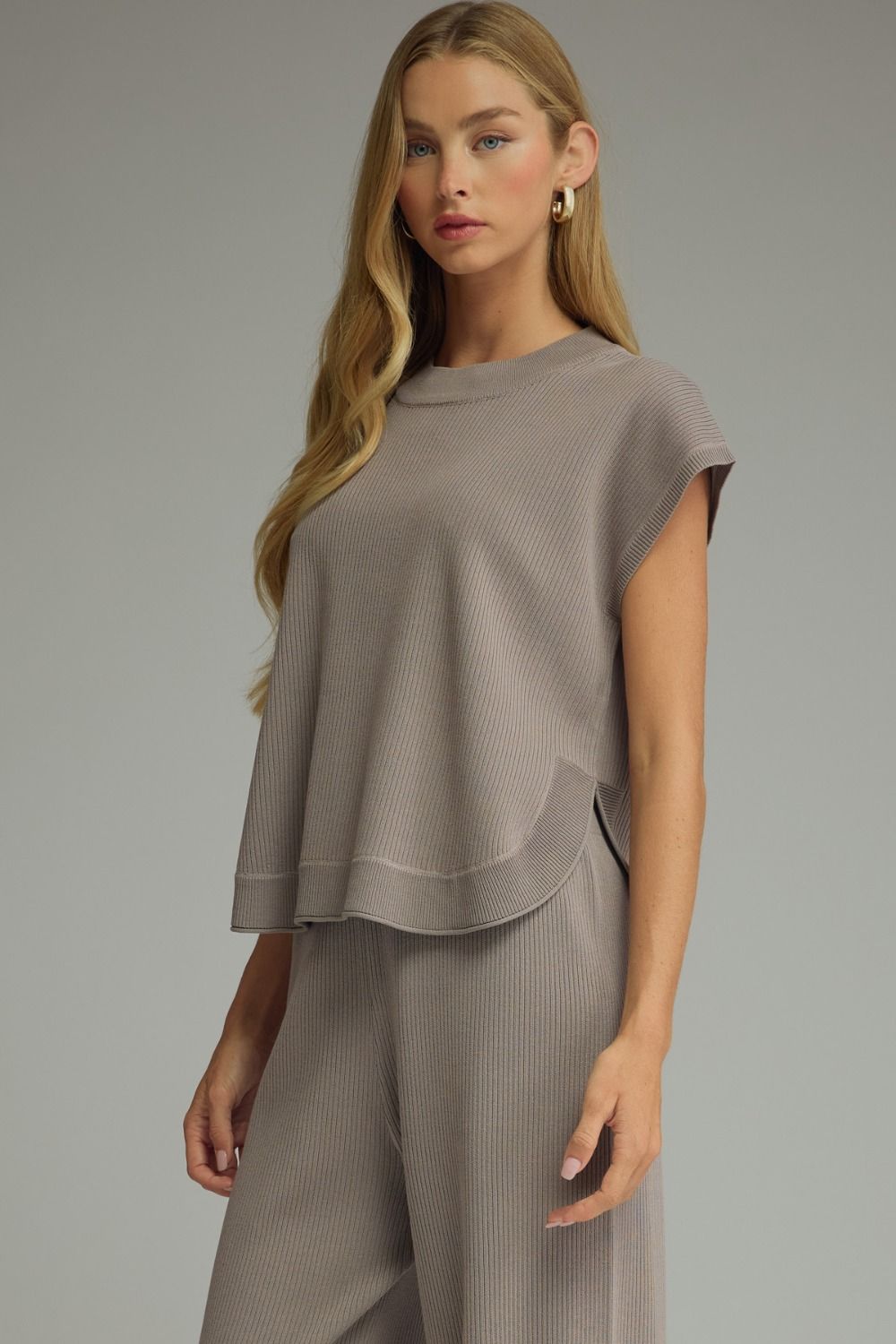 Entro-Solid short sleeve knit top with a round neck, ribbed texture, and curved side slit detail.