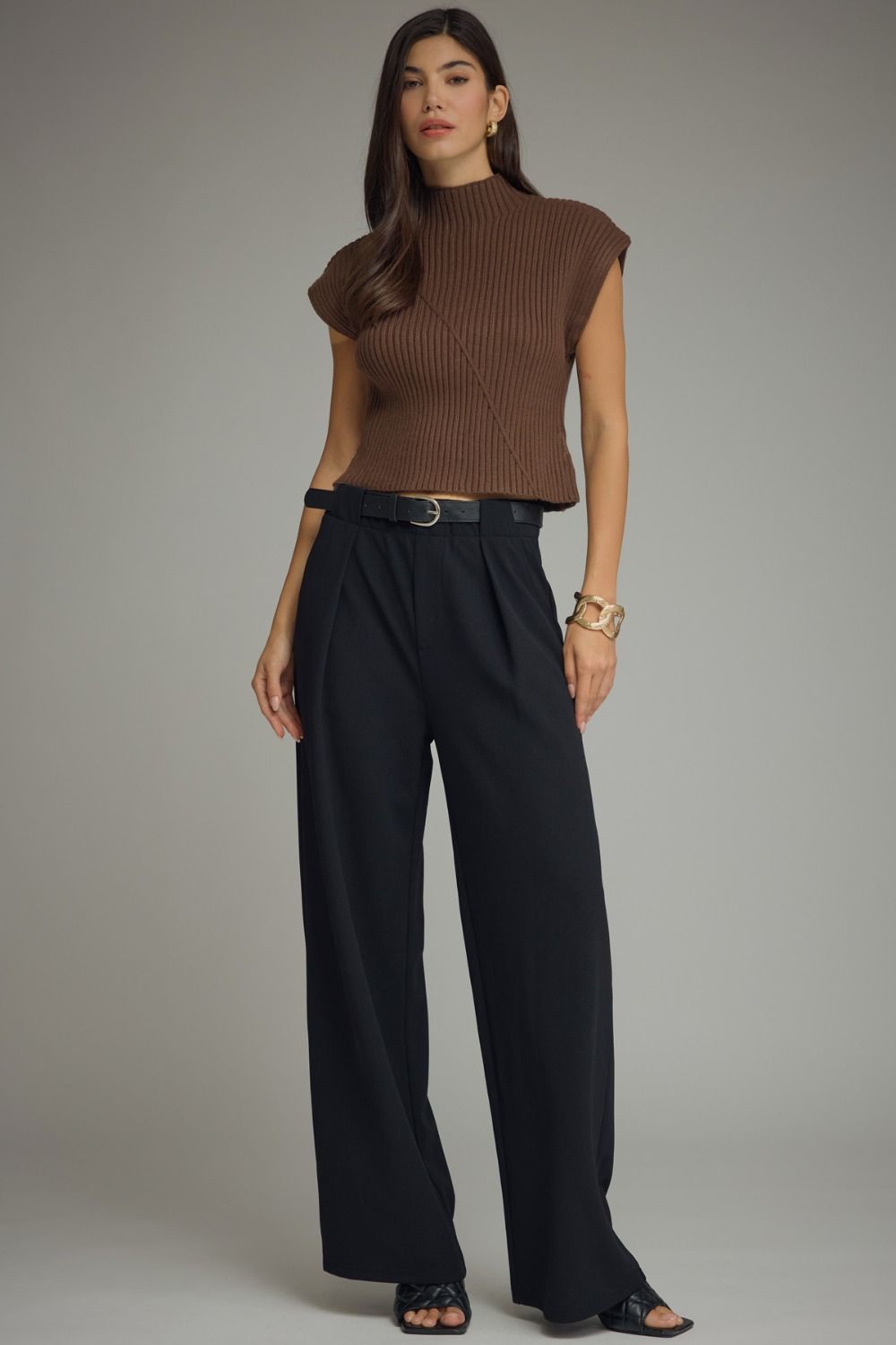 Entro-Solid cap sleeve knit top featuring ribbed texture. Mock neckline. Diagonal seam detail at front and back.