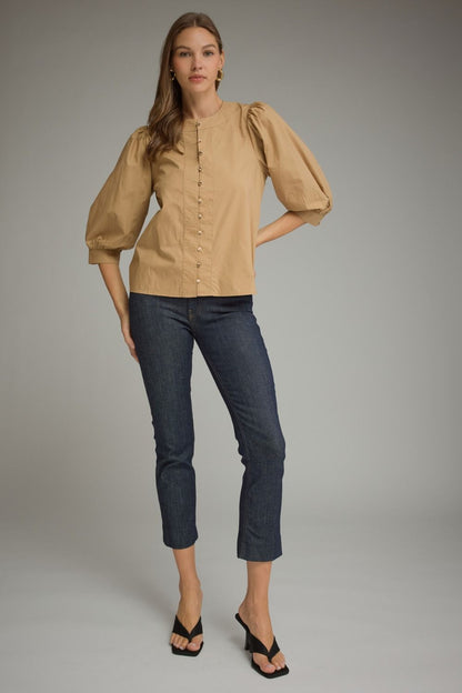 Entro-Solid ¾ balloon sleeve top with a round neckline. Button closure at front. Pintuck detail at neckline, front, and sleeve cuffs. Gathered detail at shoulders and back.