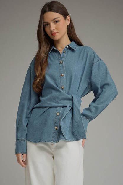 Entro-Solid denim long sleeve top featuring button closure at front and a wraparound self-tie detail. Button cuffs.