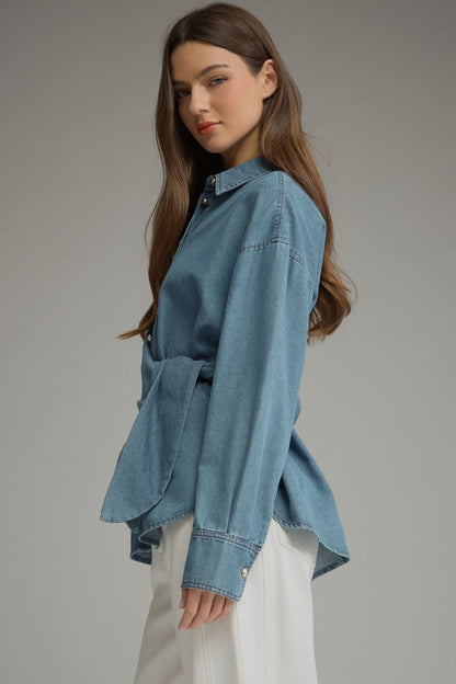 Entro-Solid denim long sleeve top featuring button closure at front and a wraparound self-tie detail. Button cuffs.