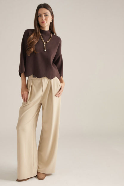 Entro-Solid ¾ sleeve sweater top with a mock neck. Scalloped hem and sleeve edges.
