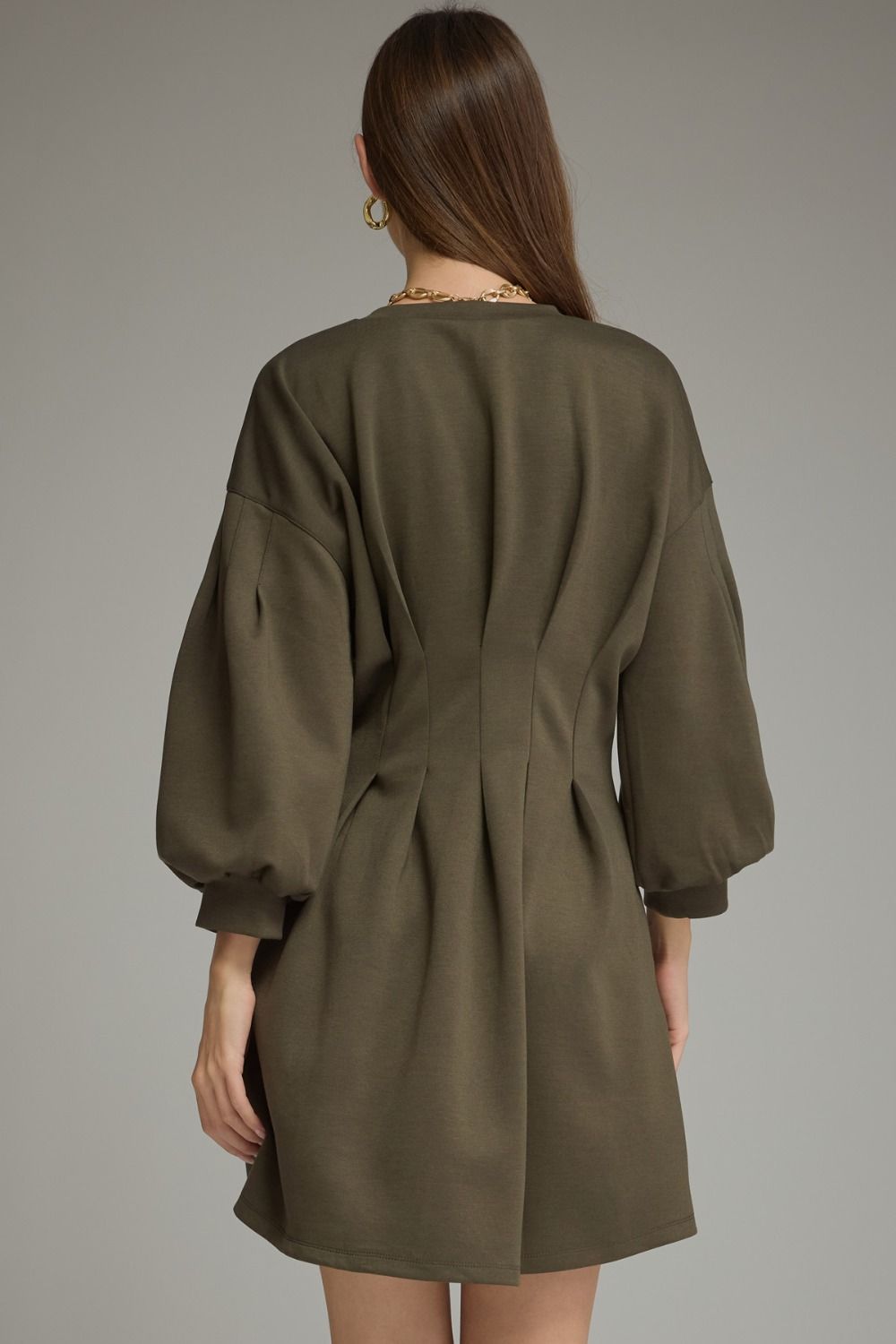 Entro-Solid long sleeve mini dress with a round neckline, pleated waist detail, and side pockets.