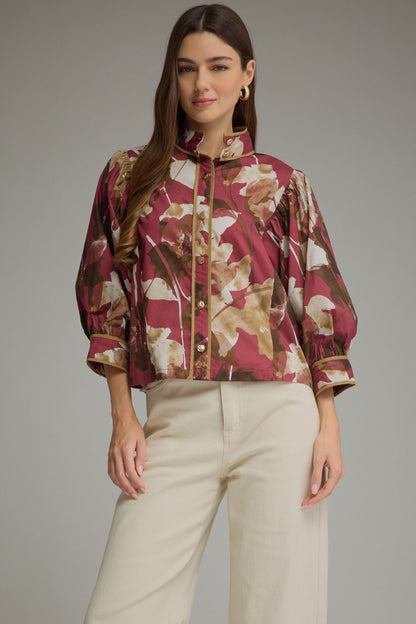 Entro-Floral print ¾ puff sleeve top with a high neckline and button closure at front.