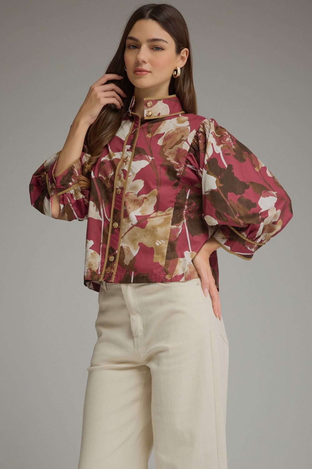 Entro-Floral print ¾ puff sleeve top with a high neckline and button closure at front.