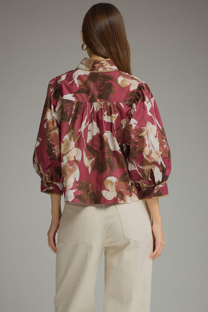 Entro-Floral print ¾ puff sleeve top with a high neckline and button closure at front.