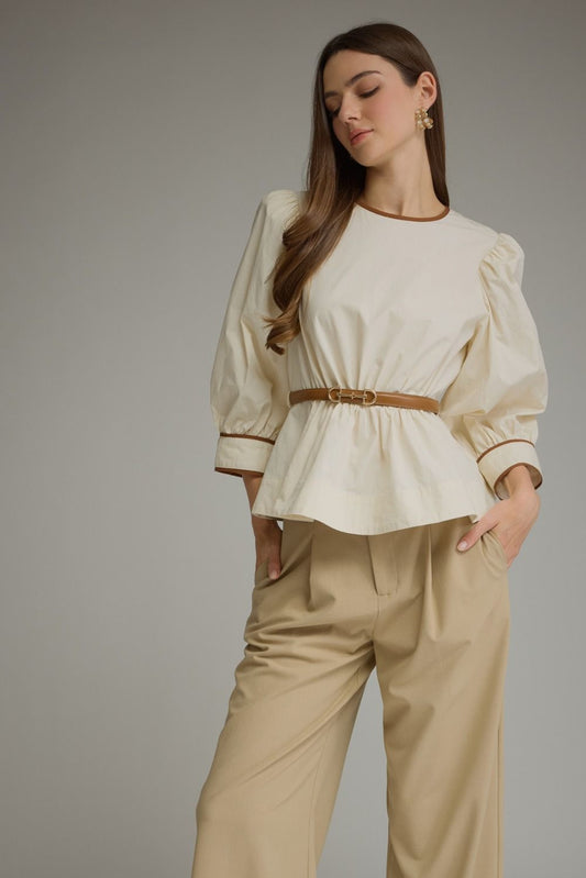 Entro-Solid long sleeve top with puff sleeves and contrast trim.