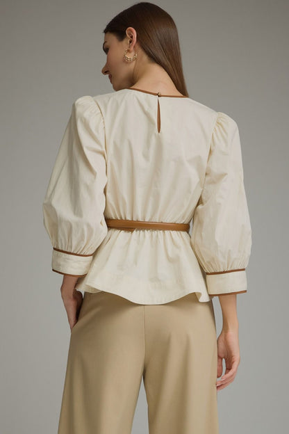 Entro-Solid long sleeve top with puff sleeves and contrast trim.