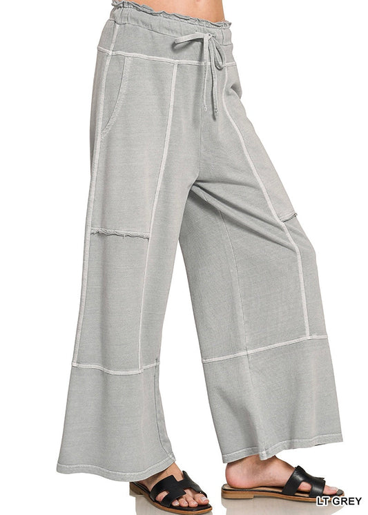 Light grey wide leg pants on a white background