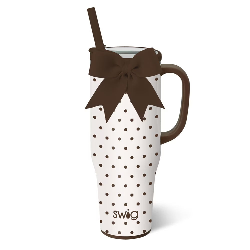 White tumbler with brown polka dots and a brown bow, featuring the 'swig' brand.