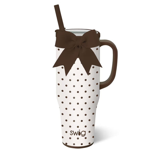 White tumbler with brown polka dots and a brown bow, featuring the 'swig' brand.