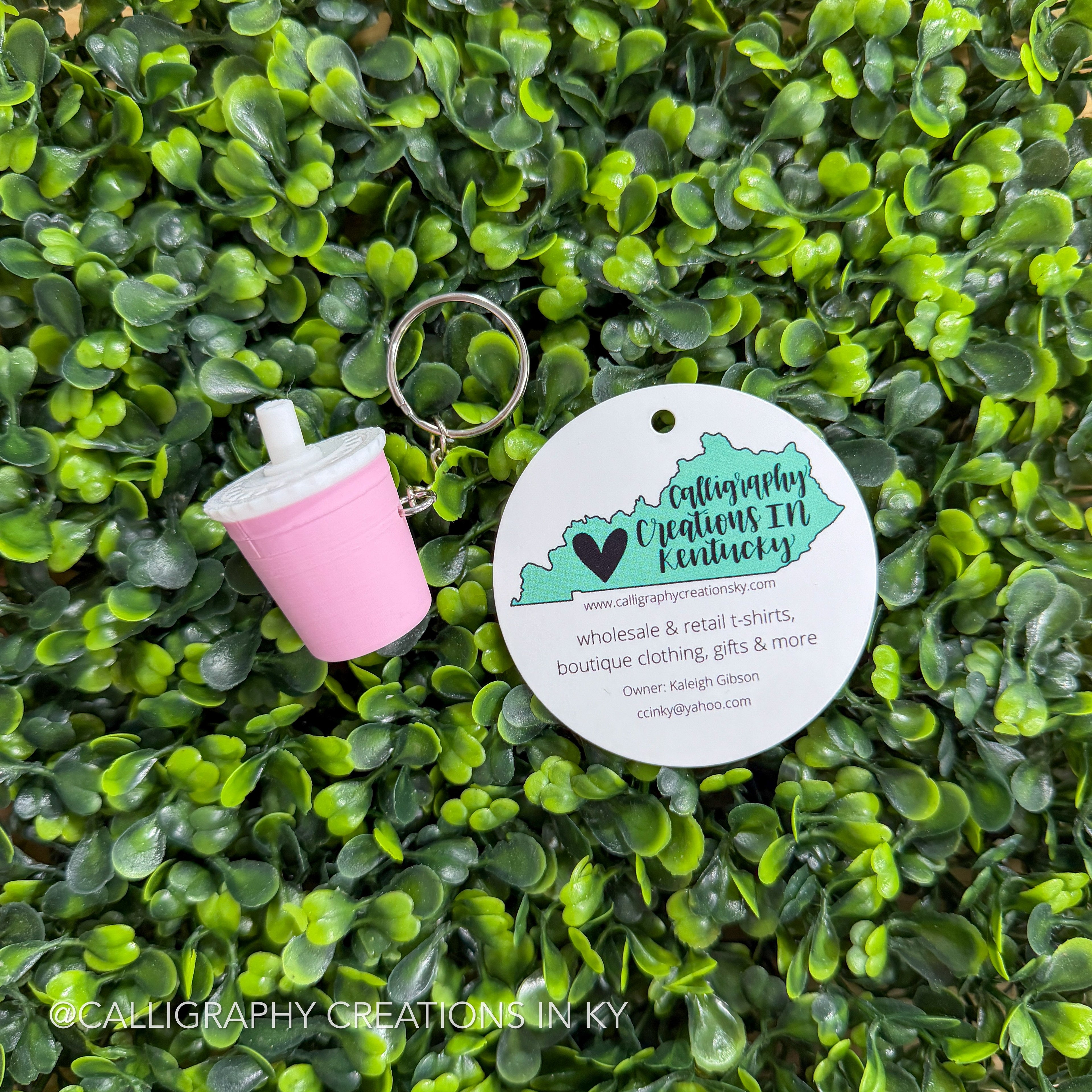Light pink key chain on greenery background with Calligraphy Creations branding