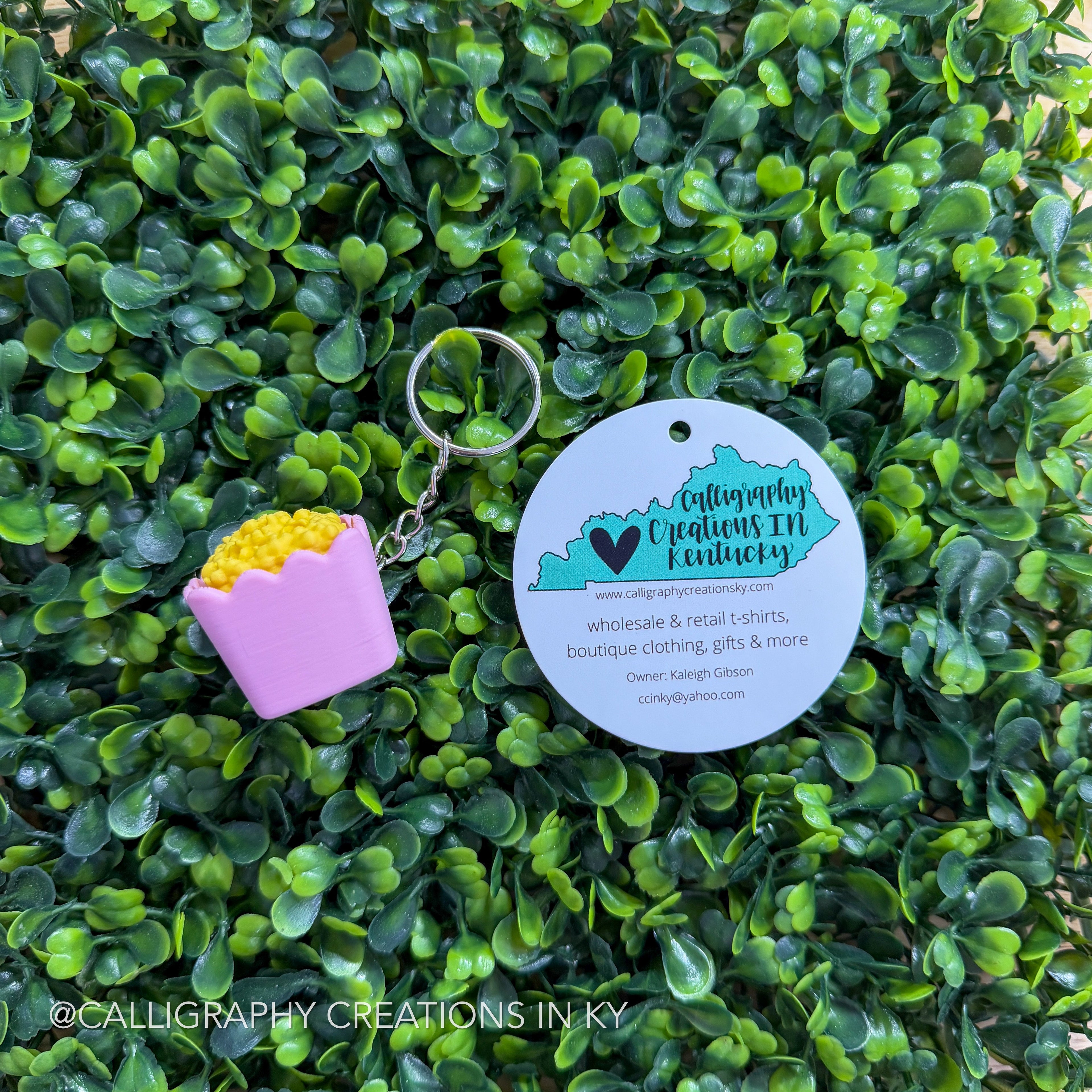 Pink popcorn fidget keychain on greenery background with Calligraphy Creations branding