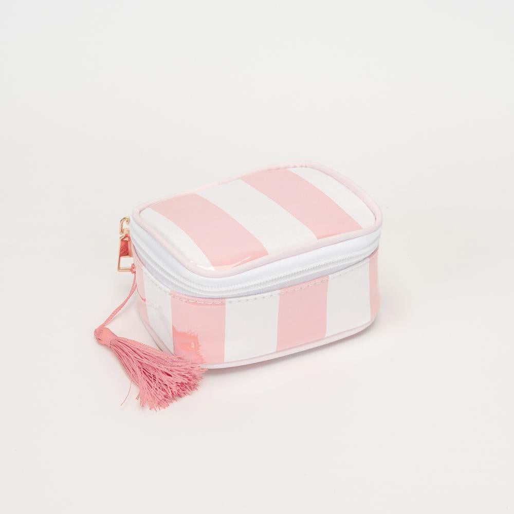A small zippered cosmetic pouch with pink and white vertical stripes, featuring a pink tassel charm and a gold zipper pull, set against a plain white background.