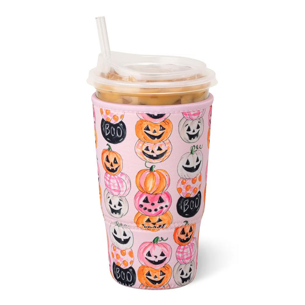 A pink insulated sleeve, covered in a Halloween-themed pattern of jack-o'-lanterns, pumpkins, ghosts, and the words 'BOO'.