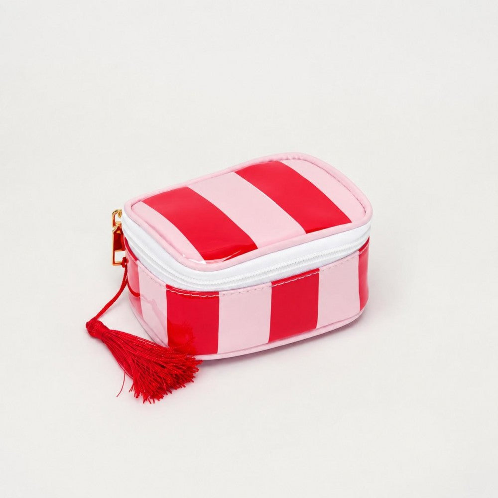 A small zippered pouch with alternating red and light pink vertical stripes, featuring a red tassel zipper pull and a gold-tone zipper pull tab, set against a plain light gray background.