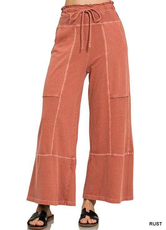 Rust colored wide leg pants on a white background