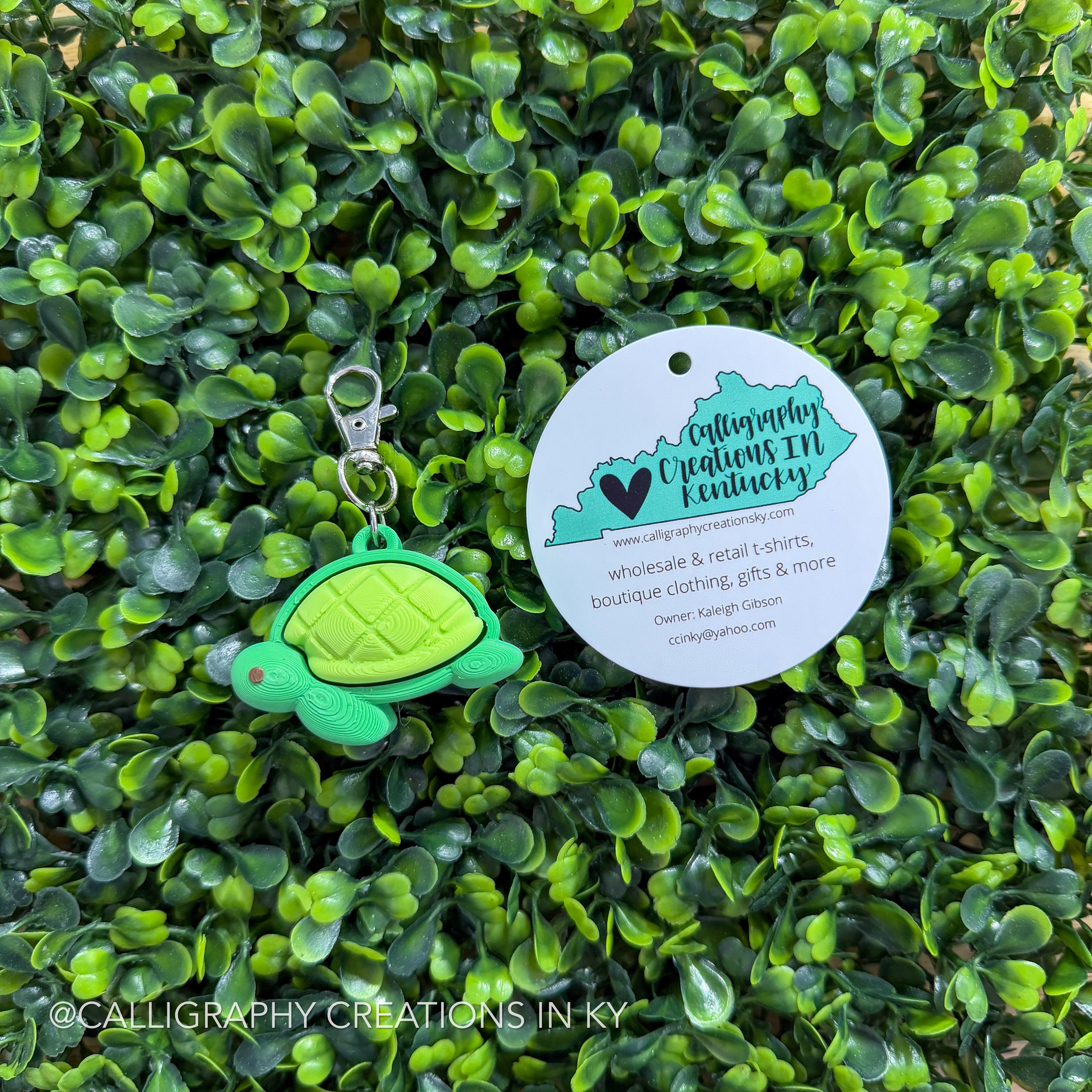 Green Turtle keychain on greenery background with Calligraphy Creations Logo