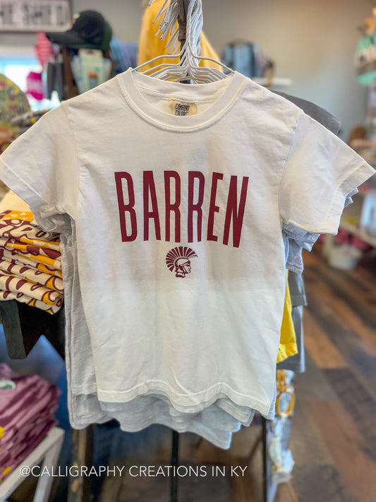 A white short-sleeve t-shirt hanging on a rack in a retail store, featuring the word 'BARREN' in dark red block letters and a small matching red crest graphic on the front.