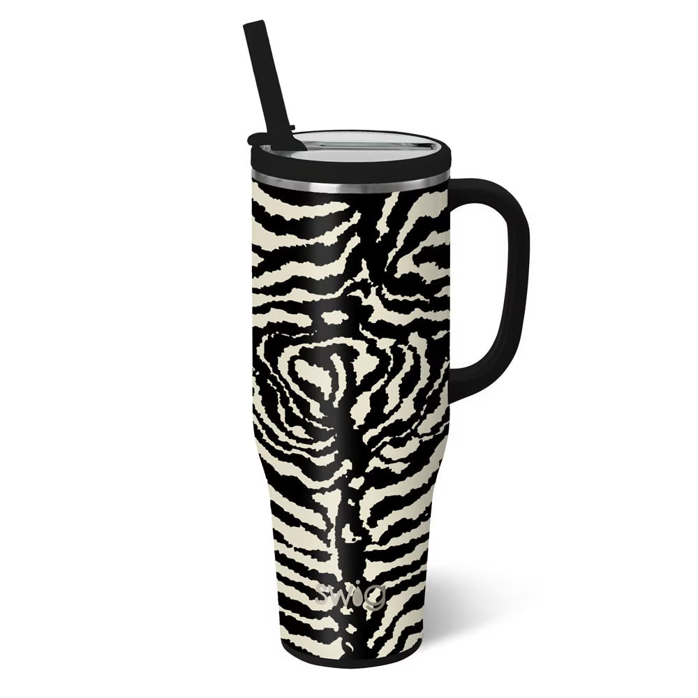 A tall insulated travel tumbler with a black handle, black lid, and black straw, featuring a black and off-white zebra-stripe pattern on the body, shown on a white background.