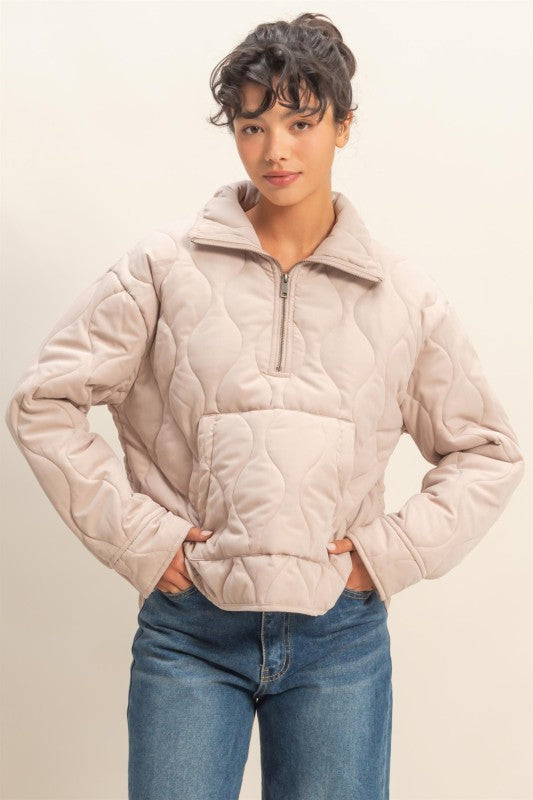Cozy quilted pullover styled with front zip and structured silhouette