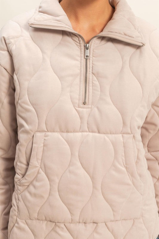 Quilted pullover layered over turtleneck for chic casual look