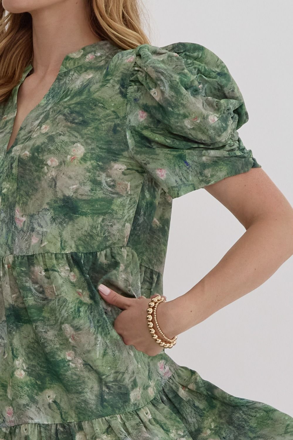 Side view of floral v-neck dress with pockets