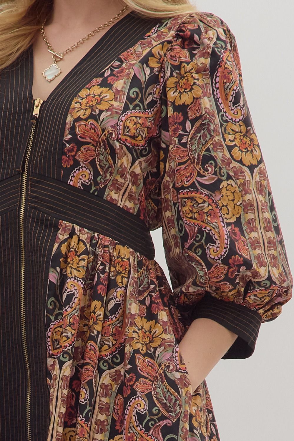 &nbsp;A zoomed-in image of the striped trim and partial zipper closure, emphasizing the intricate design and craftsmanship.