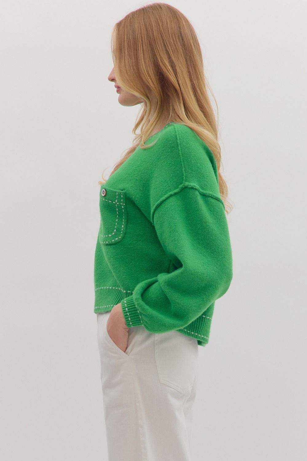 Side view of solid long sleeve sweater knit top showing contrast stitching and relaxed fit. Medium-weight, non-sheer knit fabric.”