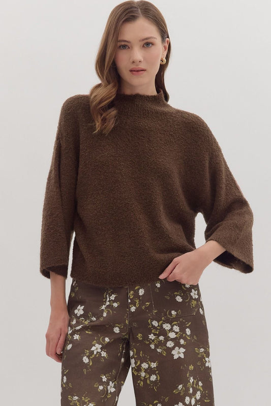 Woman wearing solid 3/4 sleeve mock neck boucle sweater knit top